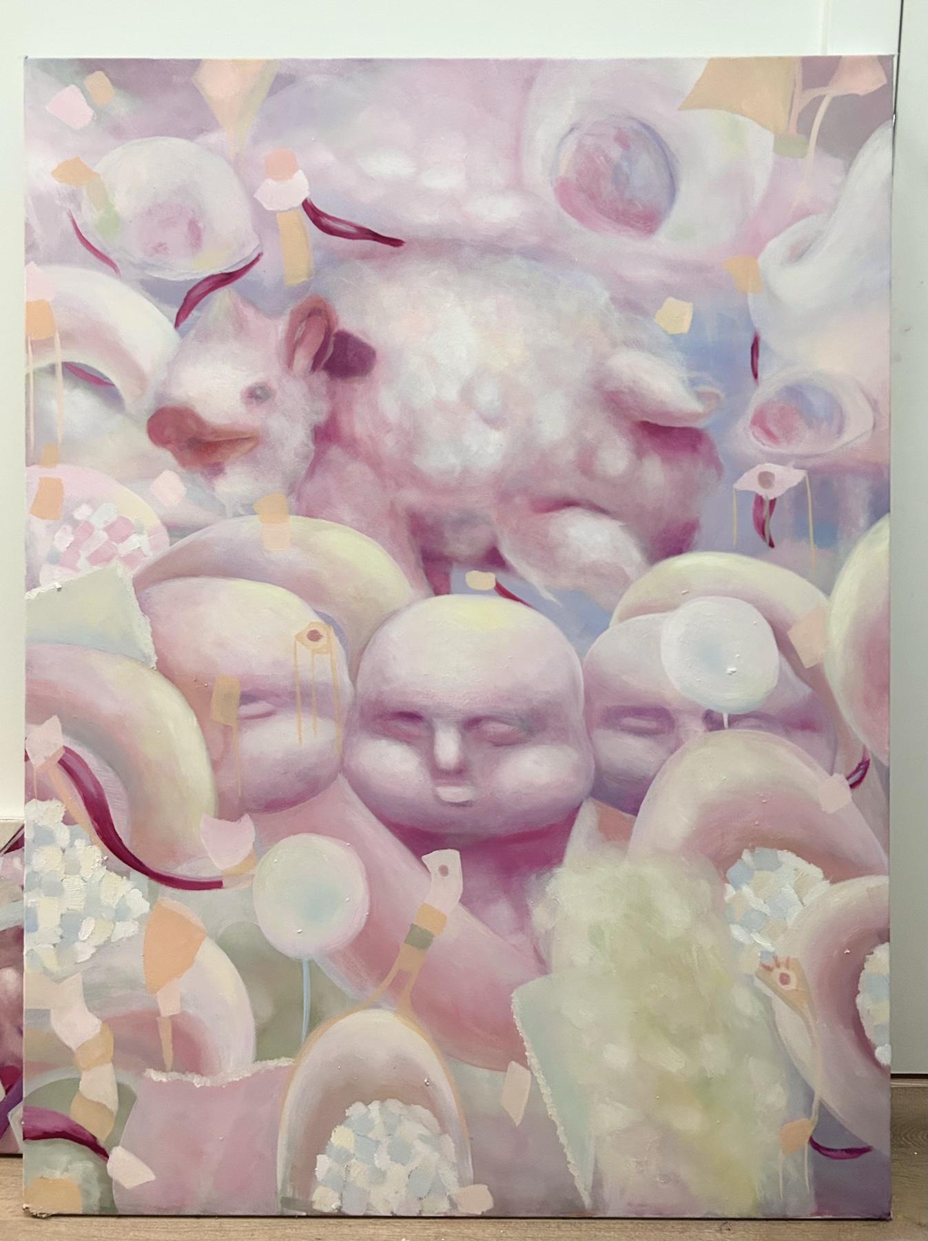 Pastel painting of a white rabbit above clustered rounded faces and abstract forms